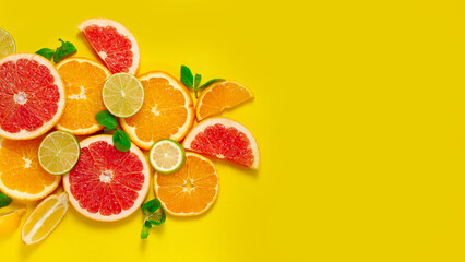 assortment of citrus fruits, on a yellow background, top view, no people, horizontal 