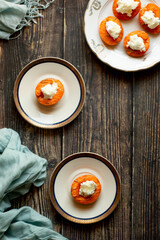Grilled apricot and ricotta cheese in a white plate.