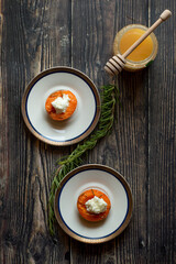Grilled apricot and ricotta cheese in a white plate.