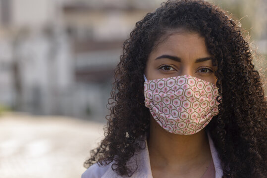 Black Woman With Facemask On Urban Background