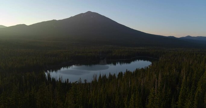 Sun sets over Mt. Bachelor and Oregon countryside, wide aerial