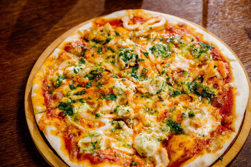 Delicious Shrimp pizza on wood table