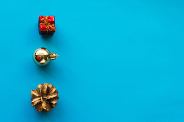 Christmas composition. Gifts, pine cones, Christmas tree decorations on a blue background. Christmas, winter, new year concept. Straight line, top view, copy space