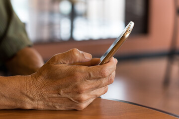 close up of hands holding a smartphone