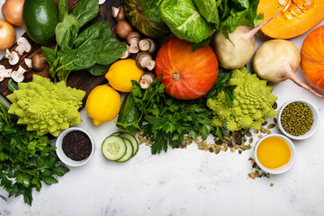 Different vegetables and greens on the white background.