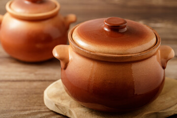 Ceramic pots set for baking dish on wooden table in the kitchen