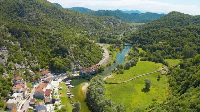 Aerial view of the the old Rijeka Crnojevica river, surrounded by picturesque green trees