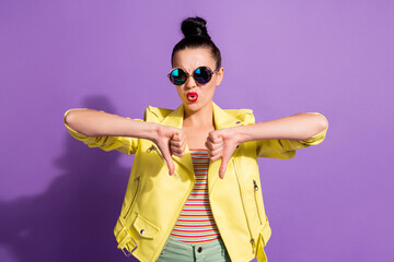 Photo of young upset serious attractive girl woman showing thumb down dislike disapprove isolated...