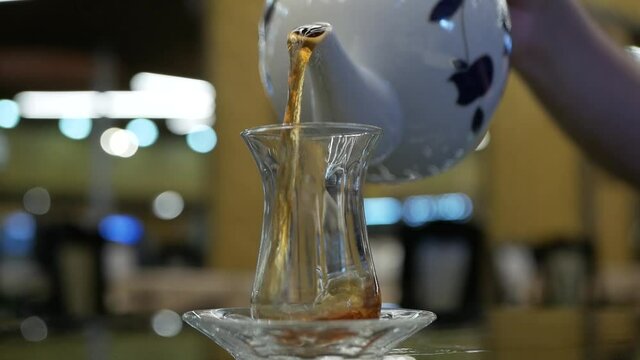 turkish glass of black tea on bokeh background