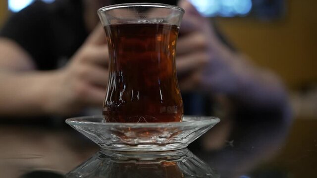 turkish glass of black tea on bokeh background