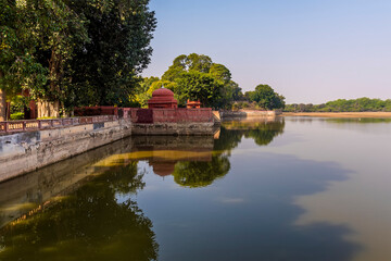 A view of reflections along the southern shore of Gajner lake in Rajasthan, India