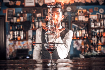 Barman makes a cocktail on the porterhouse