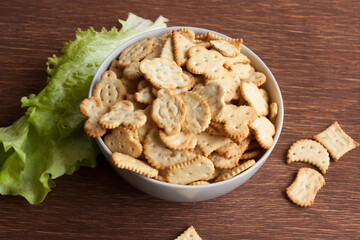 delicious dry cookies, biscuits, crackers with salt and herbs in a clay bowl