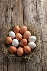 Raw eggs and hay in a basket