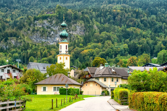 Alpine village St. Gilgen with Parish Church of Saint Egidius, mountains on background, Austria.