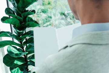 view from the back of a mockup man reading a magazine