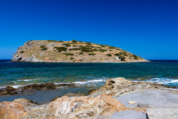 Small Greek fishing village and harbour with clear ocean