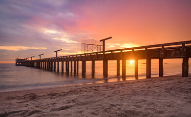Fototapeta na wymiar Long sea bridge in the sunset time.