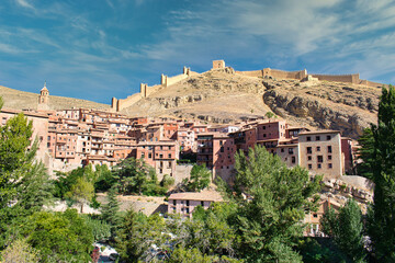 Fototapeta na wymiar Medieval town of Albarracin in the province of Teruel. At the top of the hill, ruin of the wall that fortified the town, Spain