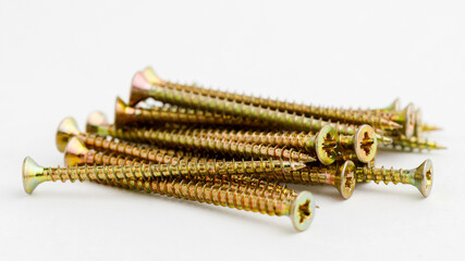 Pile of brass metal screws.