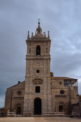 Fototapeta na wymiar old gothic style catholic church front view with a dramatic sky in palencia, spain