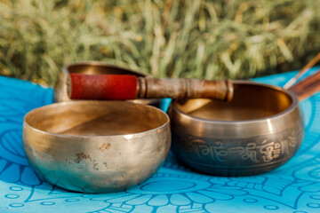 Tibetan singing bowls on the background of nature. The sound of healing. Meditation and relaxation