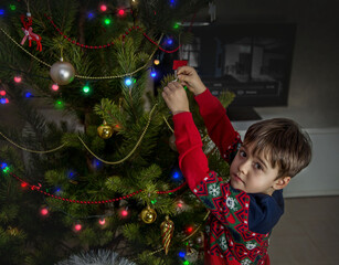 little child decorating christmas tree