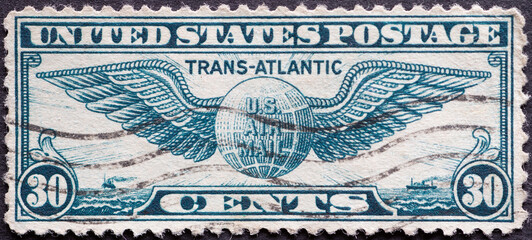USA - Circa 1939 : a postage stamp printed in the US showing the Winged Globe Transatlantic Airmail...