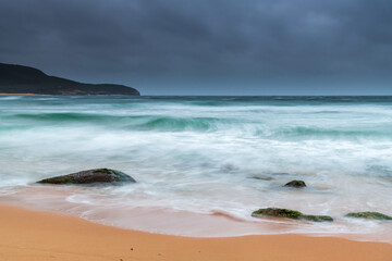 Moody Sunrise at the Seaside with Green Mossy Rocks
