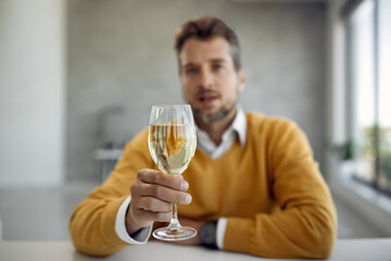 Close-up of businessman toasting with a glass of wine.