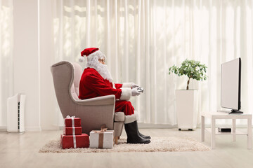 Santa claus with a joystick playing video games