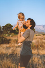 Family time father carrying child daughter playing together outdoor  lifestyle vacation man walking together with kid happy emotions