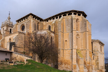 old gothic style catholic church back view with a dramatic sky in palencia, spain
