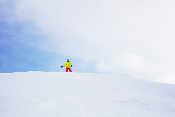 Naklejka na ściany i meble Girl snowboarder having fun in the winter ski resort.