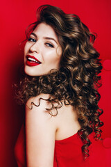 Fototapeta premium beautiful smiling woman with red lips in red dress