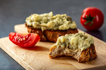 Eggplant salad with onion and mayonnaise on bitten toast
