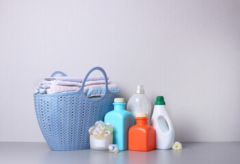 Basket with clean towels and detergents on table. Space for text. Household.Washing clothes.