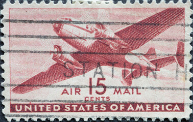 USA - Circa 1941 : a postage stamp printed in the US showing a twin-motored transport airplane 15c airmail - obrazy, fototapety, plakaty
