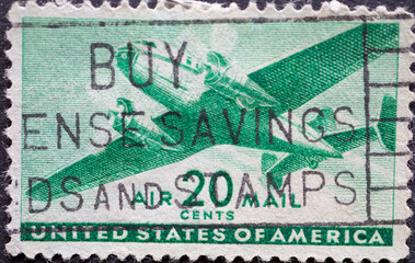 USA - Circa 1941: a postage stamp printed in the US showing a twin-motored transport airplane 20c...
