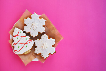On a pink background, New Year's gingerbread, orange, cinnamon.Composition with empty space for text.Top view, flat lay.
