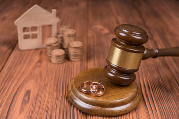 Divorce property division concept. Judge hammer, home and coin money. Court law