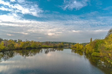 Fototapeta na wymiar The Rostavitsya river in the Kyiv region with dense deciduous trees on both banks. Ukraine