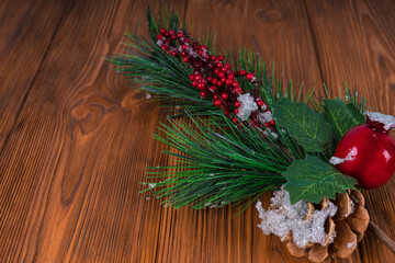 Christmas decoration bouquet in snow on wooden background. New Year, Christmas tree branches, balls and cones