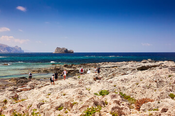 TGRAMVOUSA - BALOS, THE CRETE ISLAND, GREECE - JUNE 4, 2019: The people on the beach of Gramvousa island. 