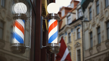 Bright barbershop pole spinning and reflecting in mirror