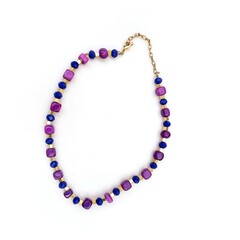 Golden necklace with gemstones isolated on a white background