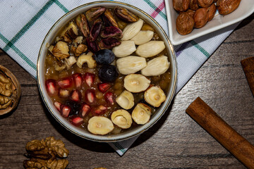 Traditional Noah's pudding, assurance in a white bowl, rustic table, aşure, aşure