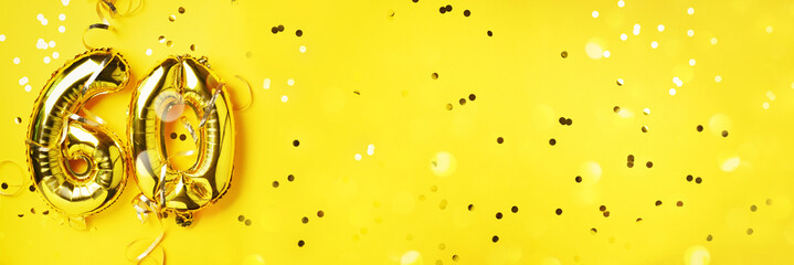 Gold foil balloon number, digit sixty. Birthday greeting card, inscription 60. Anniversary celebration event. Banner. Golden numeral, yellow background. Numerical digit, light bokeh, glitter.