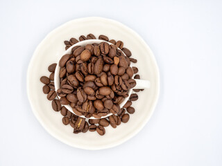 coffee beans in a white cup on the background