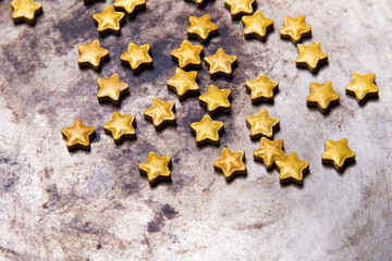 Small golden stars on a old metal background, copy space
